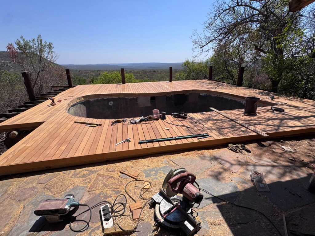 Timber decking laid around a pool at a lodge