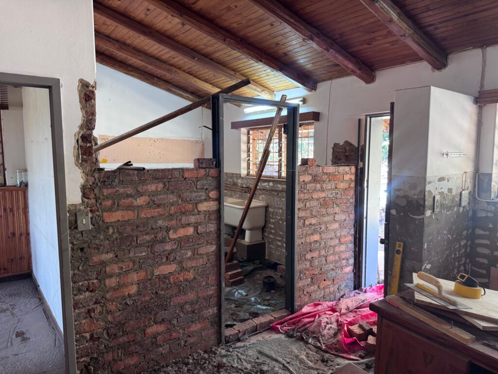 New brick wall with steel door frame during an interior alteration